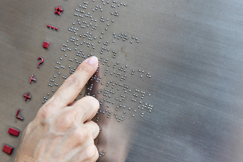 Picture of a hand reading braille